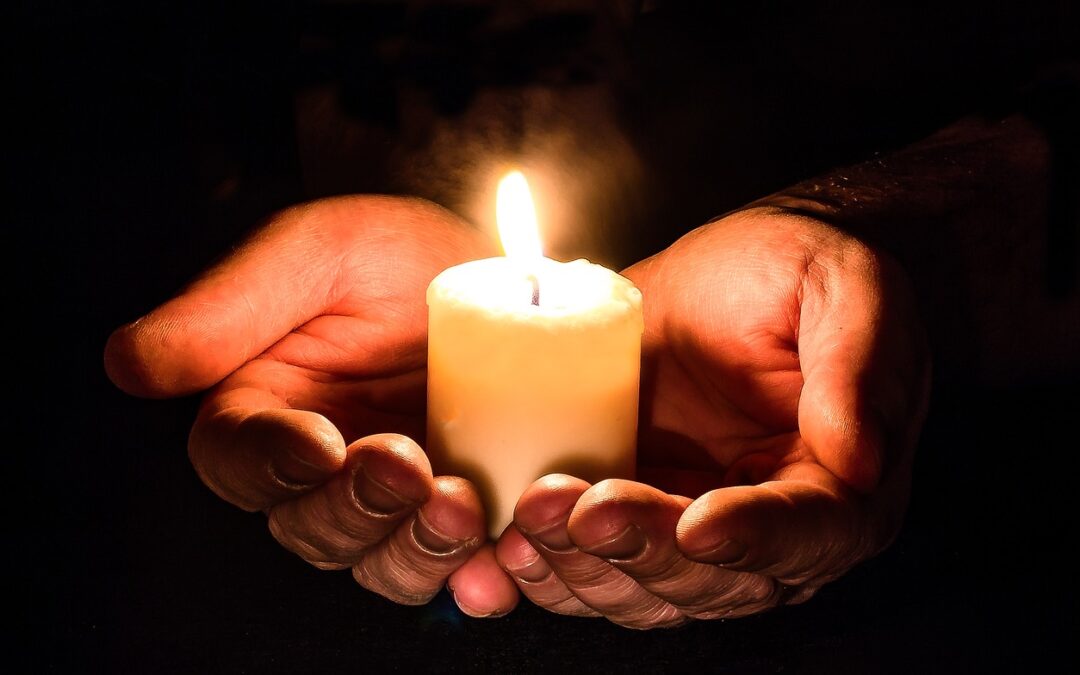 Hands holding candle